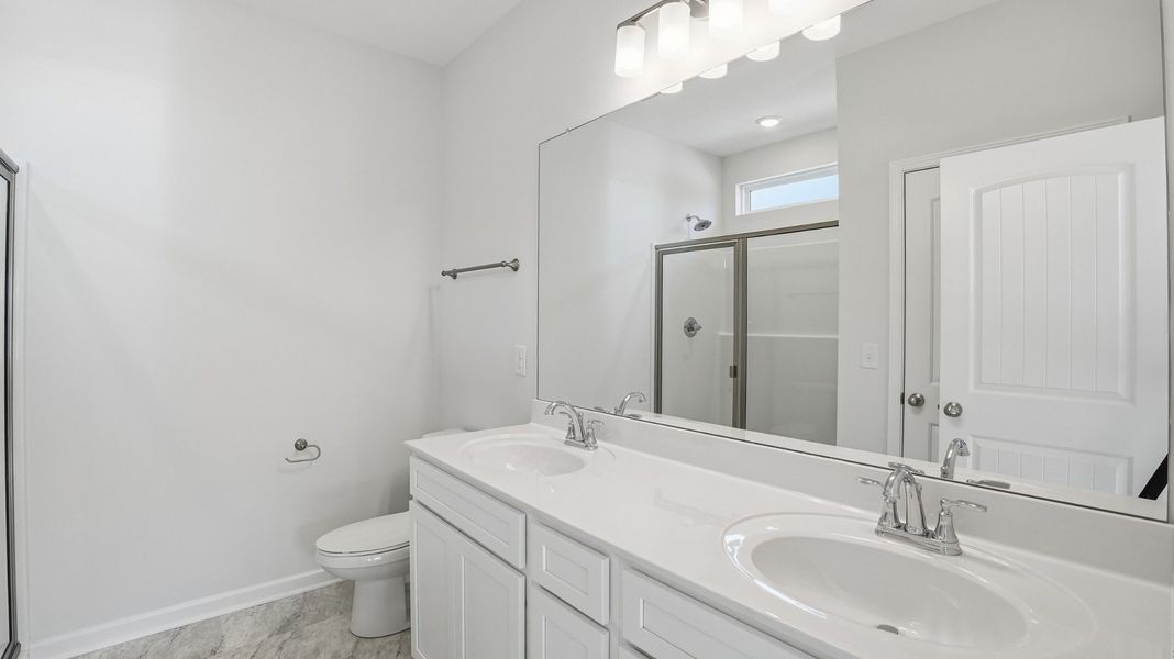 primary bathroom with double sinks, 5' shower, linen closet