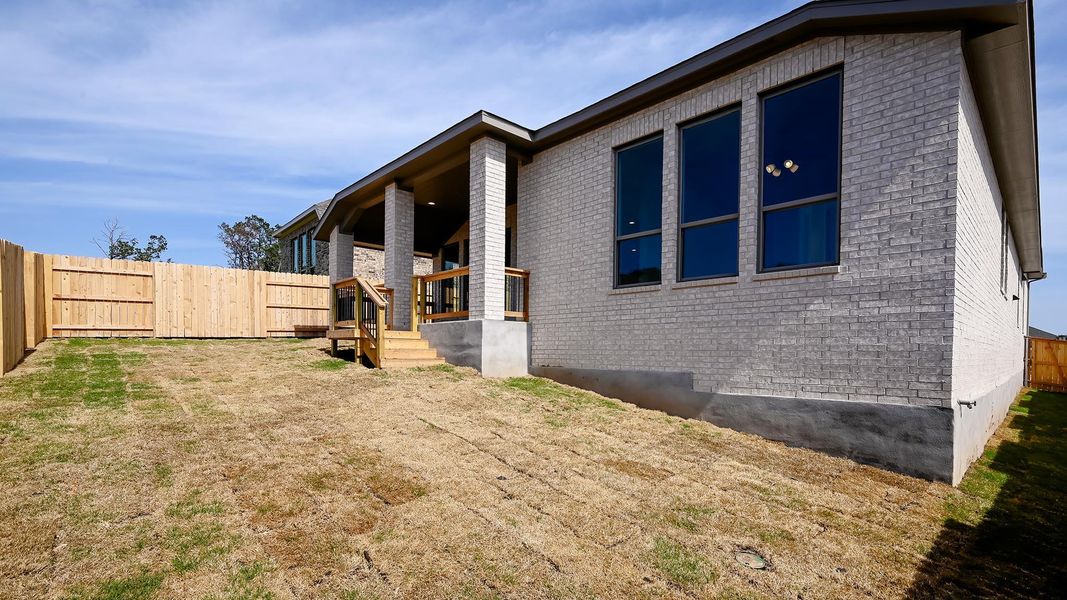 View of home's exterior with a fenced backyard and brick siding View of home's exterior with a fenced backyard and brick siding