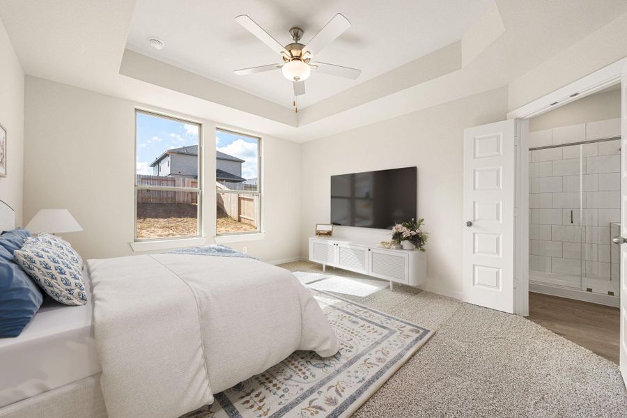 This serene primary suite offers a spacious layout with large windows that fill the room with natural light. The tray ceiling adds a touch of elegance, while the en-suite bath provides a private retreat for relaxation. This serene primary suite offers a spacious layout with large windows that fill the room with natural light. The tray ceiling adds a touch of elegance, while the en-suite bath provides a private retreat for relaxation.