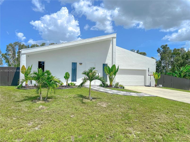 Front exterior of a new home in , Lehigh Acres, FL, highlighting curb appeal (Image 1). Front exterior of a new home in , Lehigh Acres, FL, highlighting curb appeal (Image 1).