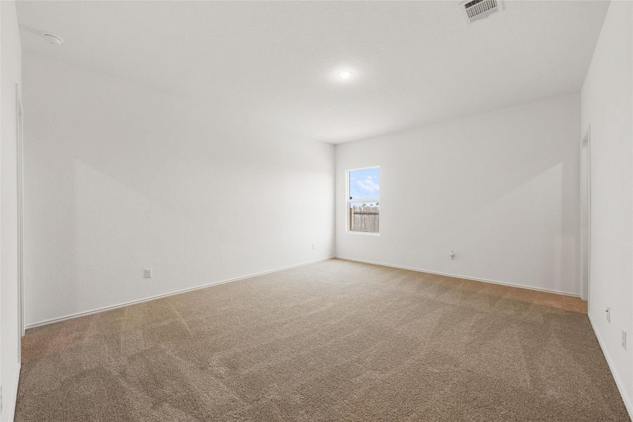 Spare room with carpet and a smoke detector Spare room with carpet and a smoke detector