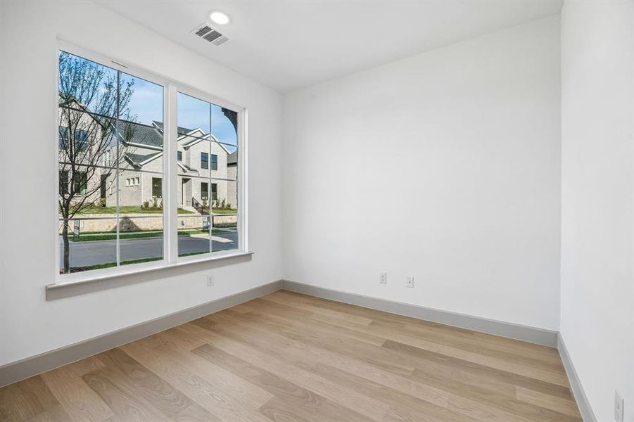 The professional working from home will appreciate this private home office with oversized windows providing tons of natural light.