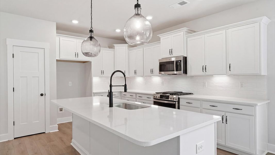 Well-designed kitchen with a center island and tasteful finishes that elevate everyday living at Creeks at Midway
