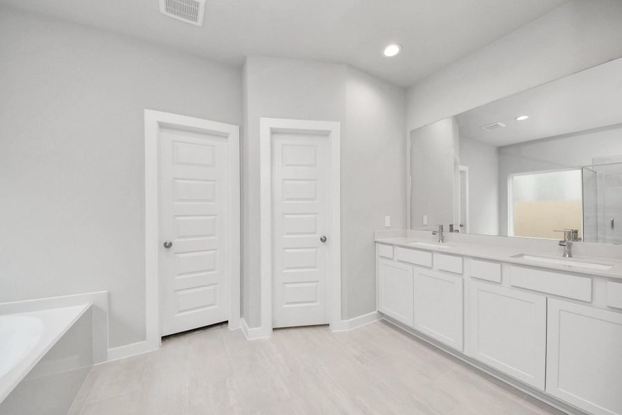 Elevate your daily routine at the elegant vanity, now equipped with double sinks, light countertops, modern hardware, and beautiful recessed lights. Sample photo of completed home with similar floor plan. Actual colors and selections may vary. Elevate your daily routine at the elegant vanity, now equipped with double sinks, light countertops, modern hardware, and beautiful recessed lights. Sample photo of completed home with similar floor plan. Actual colors and selections may vary.