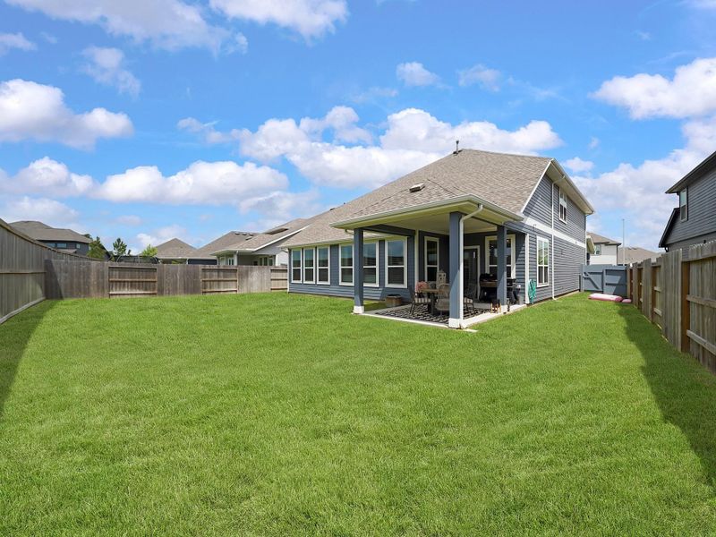 The expansive yard offers plenty of room to create your ideal outdoor retreat while still maintaining open green space.