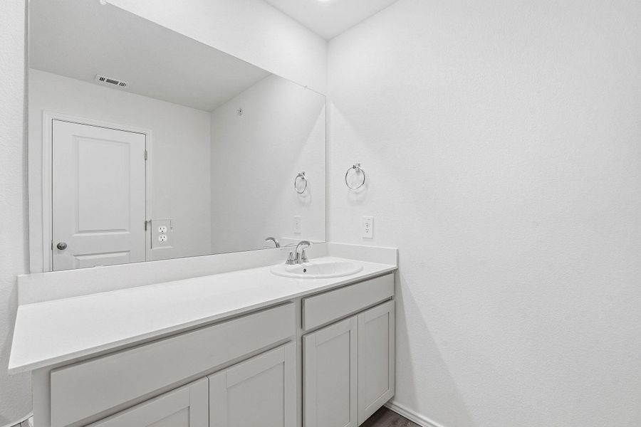 Bathroom vanity with a white countertop and integrated sink Bathroom vanity with a white countertop and integrated sink