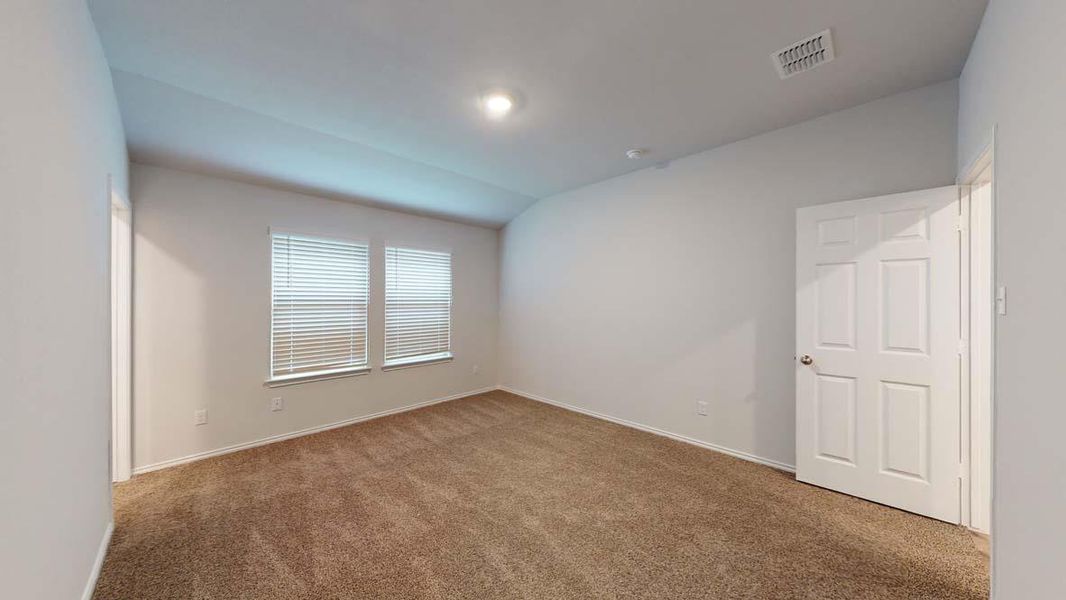 Carpeted room featuring two windows with blinds, a white paneled door, and recessed lighting