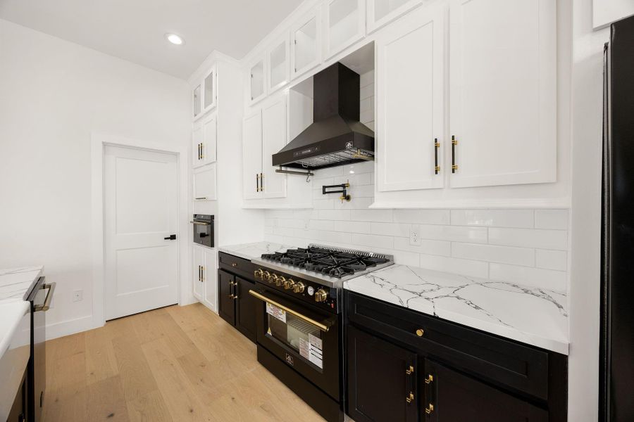 A closer view from the kitchen highlights the cooking area and provides a glimpse into the spacious walk-in pantry, offering plenty of storage and easy access from the main kitchen.