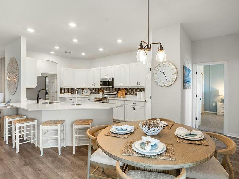 The bar and adjacent cafe provide desirable kitchen dining space - Westin II by Highland Homes