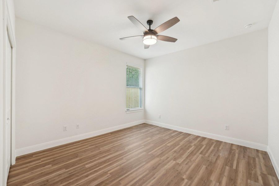 Bedroom 3 with baseboards, a ceiling fan, and wood plank vinyl floor Bedroom 3 with baseboards, a ceiling fan, and wood plank vinyl floor