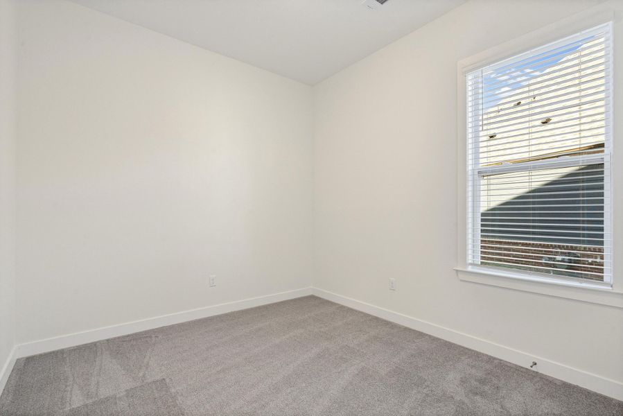 Empty room with carpet floors and baseboards