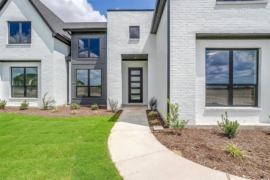 Doorway to property featuring a yard