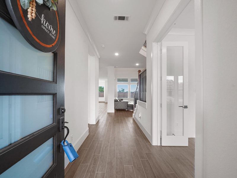 Step into a welcoming foyer with soaring ceilings, warm neutral tones, and elegant tile floors that set the stage for the rest of the home. Natural light filters in from multiple angles, creating an open and inviting atmosphere as soon as you walk through the door.
