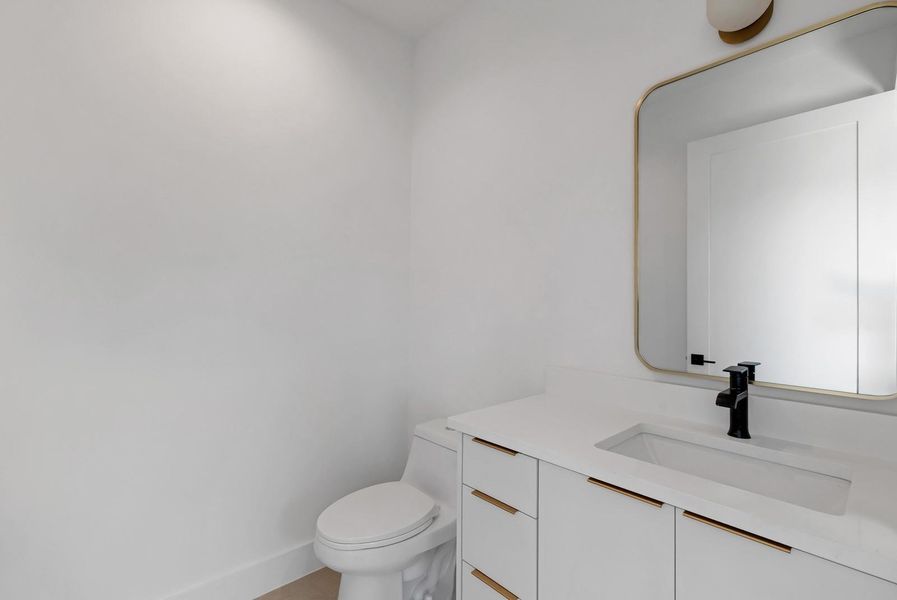 Bathroom featuring vanity and toilet Bathroom featuring vanity and toilet