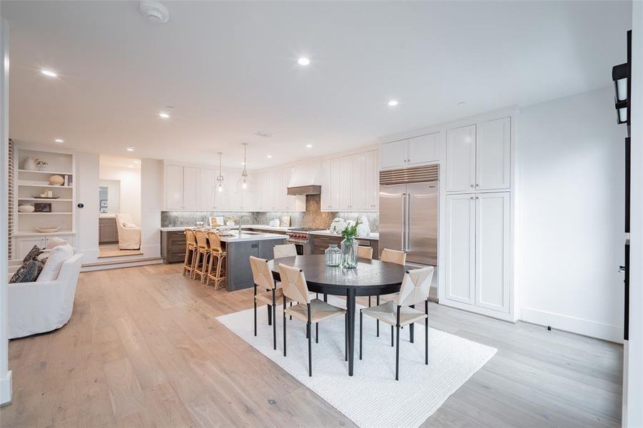 Dining space with sink and light hardwood / wood-style flooring