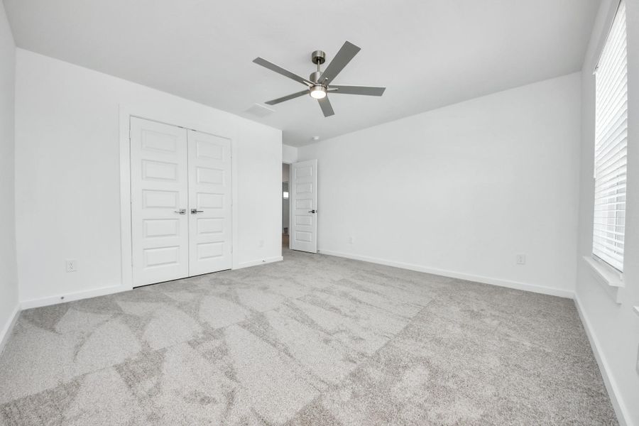 Generously sized secondary bedrooms featuring spacious closets, soft and inviting carpeting underfoot, large windows allowing plenty of natural light, and the added touch of privacy blinds for your personal retreat.