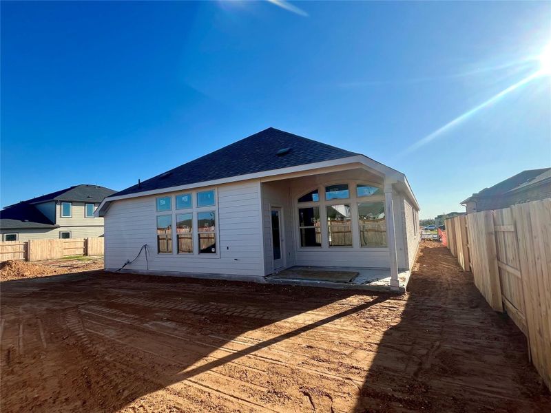 Rear view of property featuring a shingled roof and a patio Rear view of property featuring a shingled roof and a patio