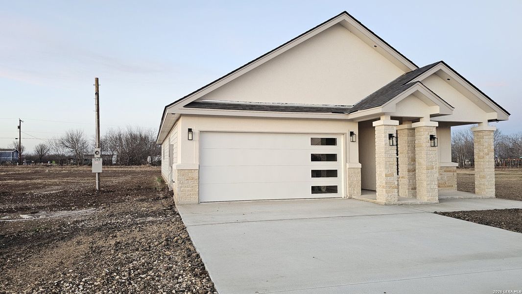 Front exterior of a new home in , Atascosa, TX, highlighting curb appeal (Image 13).