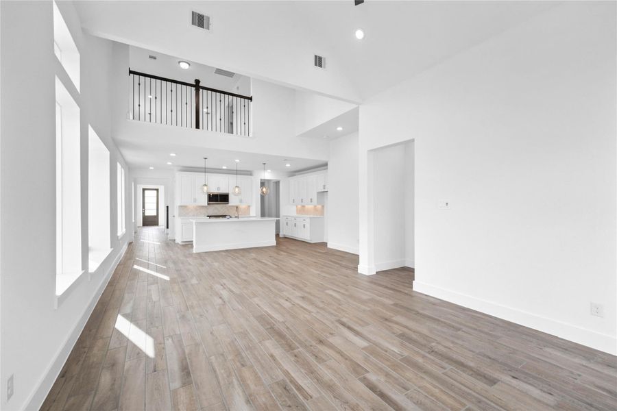 Create lasting memories around the table with family and friends in the dining! It showcases high ceilings, large windows, wood-look tile flooring, and recessed lighting for a warm and welcoming atmosphere.