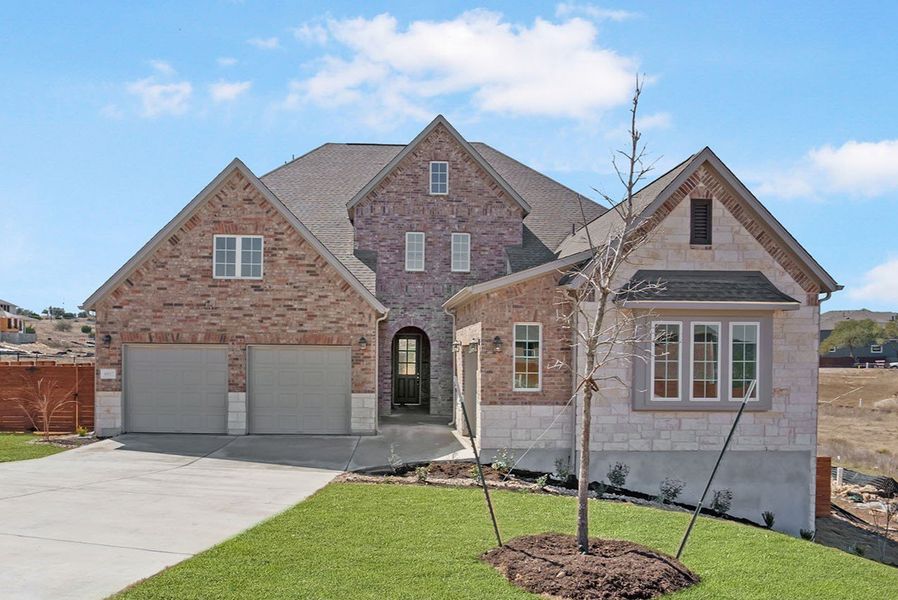 Representative exterior photo of a completed home built from the Hasley by Ashton Woods in The Estates at La Cima, San Marcos, TX (Image 1).