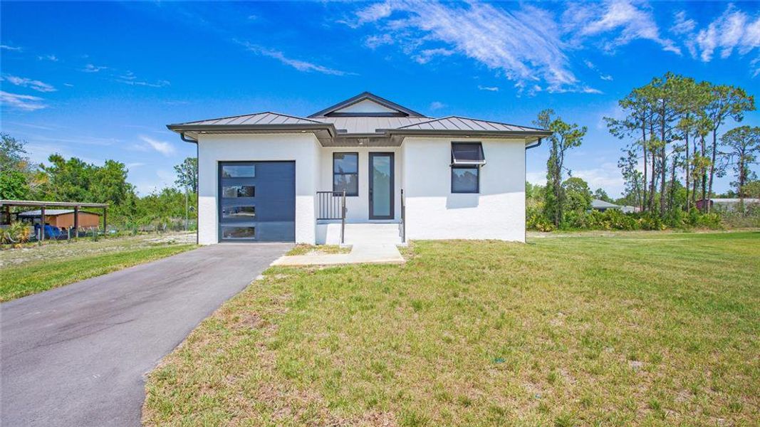Front exterior of a new home in , Naples, FL, highlighting curb appeal (Image 1). Front exterior of a new home in , Naples, FL, highlighting curb appeal (Image 1).