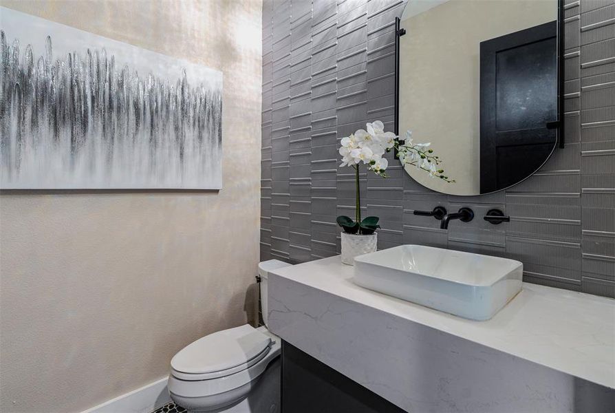 Bathroom featuring vanity and tile walls