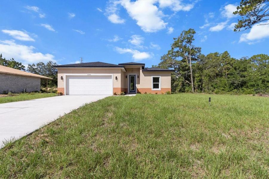 Front exterior of a new home in , Citrus Springs, FL, highlighting curb appeal (Image 19).