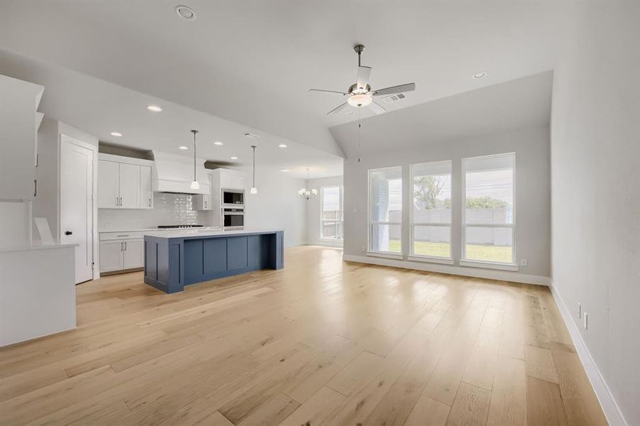 Open concept living area featuring wood-finish flooring Open concept living area featuring wood-finish flooring