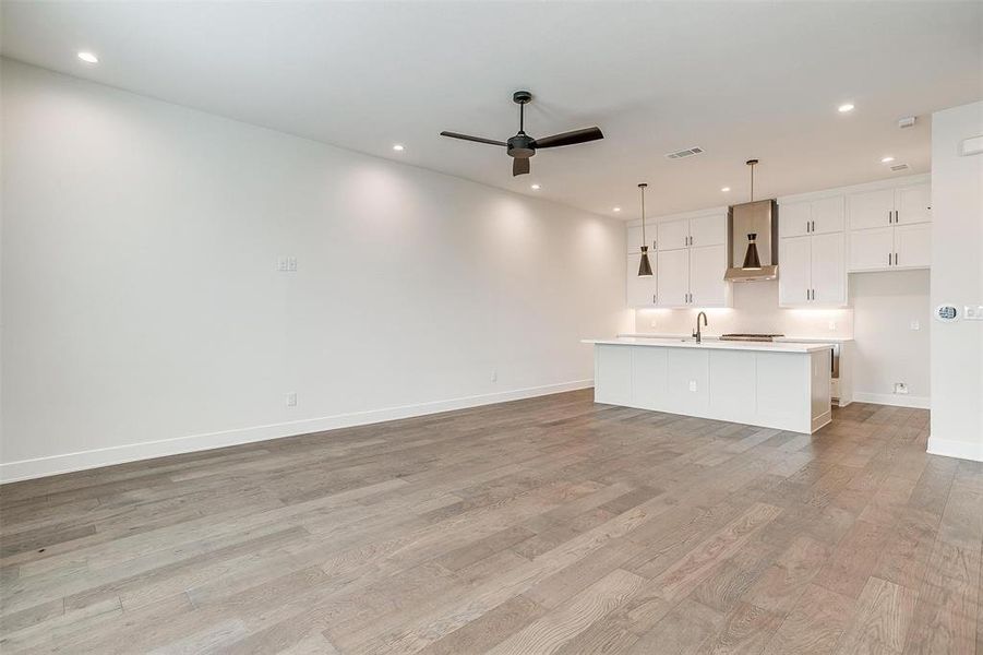 Discover the elegance of the main living area, featuring white oak engineered hardwoods and designer lighting that exudes sophistication.