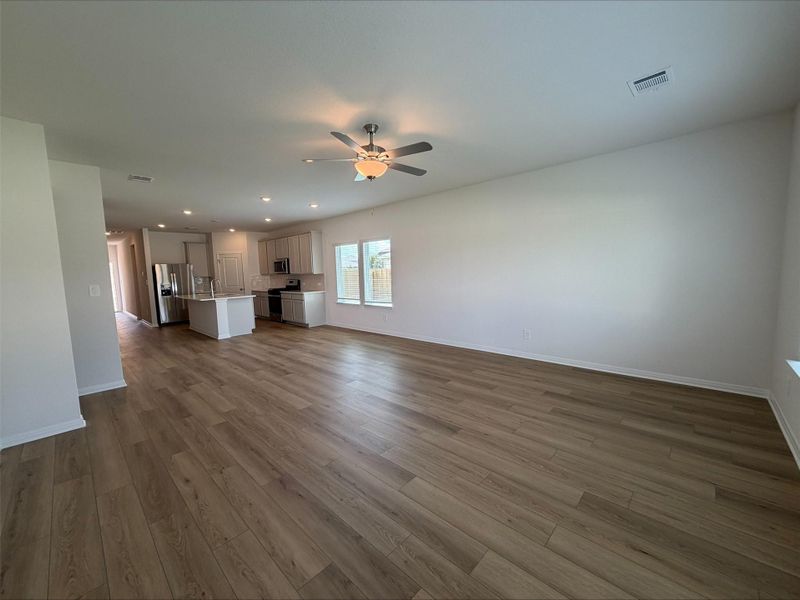 Unfurnished living room with dark wood-style flooring, recessed lighting, and a ceiling fan Unfurnished living room with dark wood-style flooring, recessed lighting, and a ceiling fan
