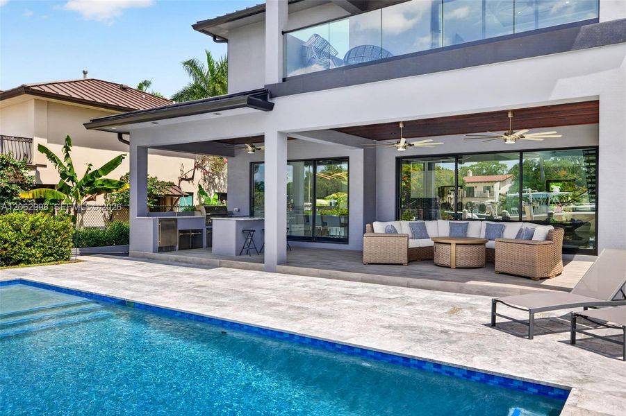 Salt chlorinated pool w/ water features, LED color changing light, sun shelf with umbrella hole and in water stools. Stone decking surrounds the pool