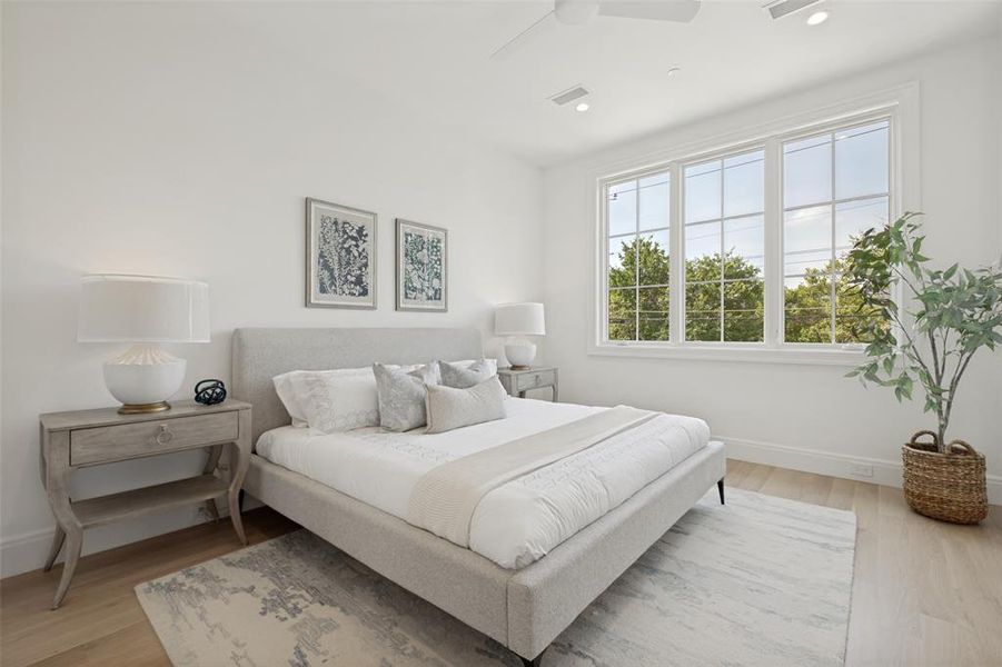 Spacious primary bedroom featuring wide-plank flooring, abundant natural light, and an ensuite bathroom, creating the perfect retreat. Spacious primary bedroom featuring wide-plank flooring, abundant natural light, and an ensuite bathroom, creating the perfect retreat.