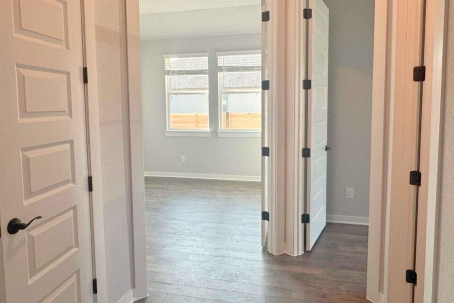 Hall with dark wood finished floors and baseboards Hall with dark wood finished floors and baseboards