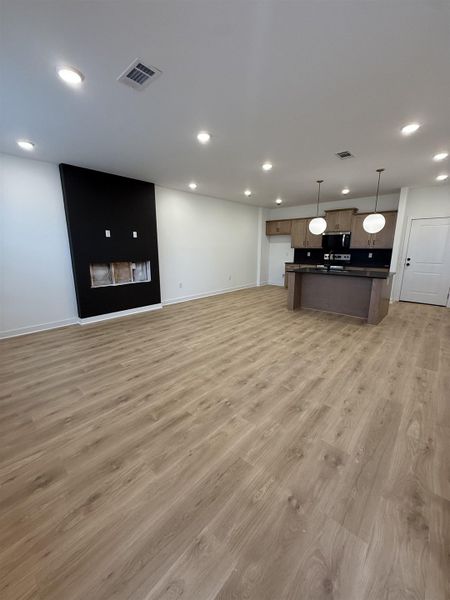 Unfurnished living room featuring light wood-style flooring and recessed lighting