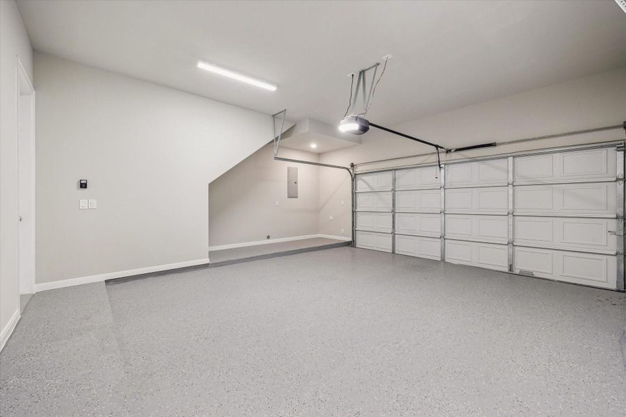 Attached 2-car garage with epoxy flooring.