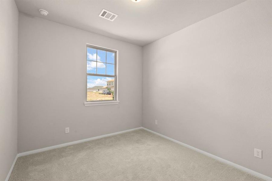 Your secondary bedroom features plush carpet, fresh paint, closet, and a large window that lets in plenty of natural lighting.