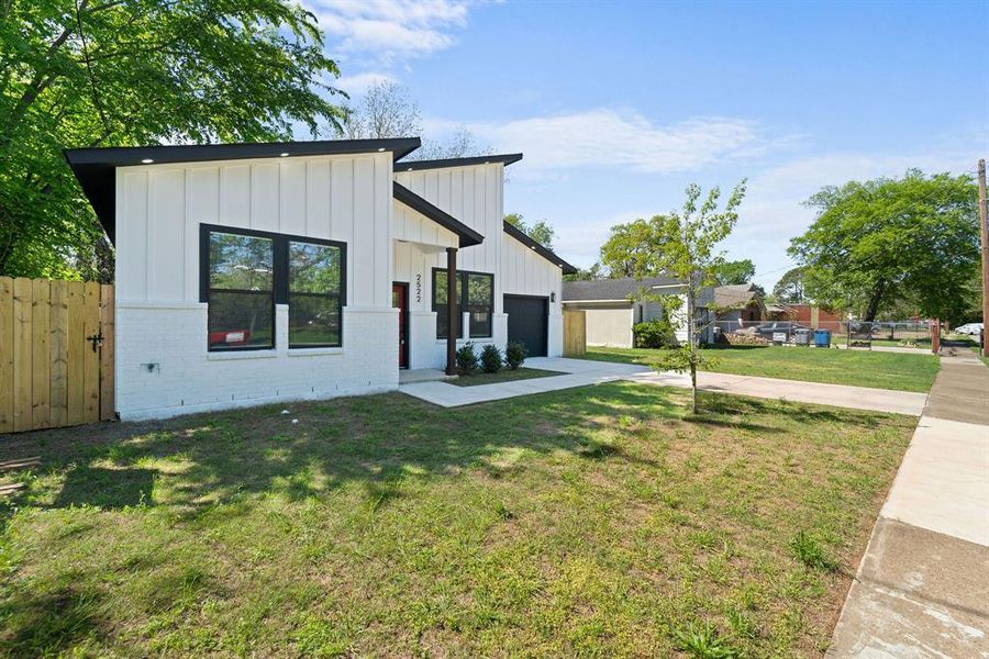 Modern farmhouse with a front yard and a garage