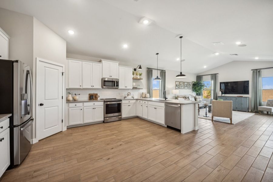 Kitchen with vaulted ceiling and pendant lighting