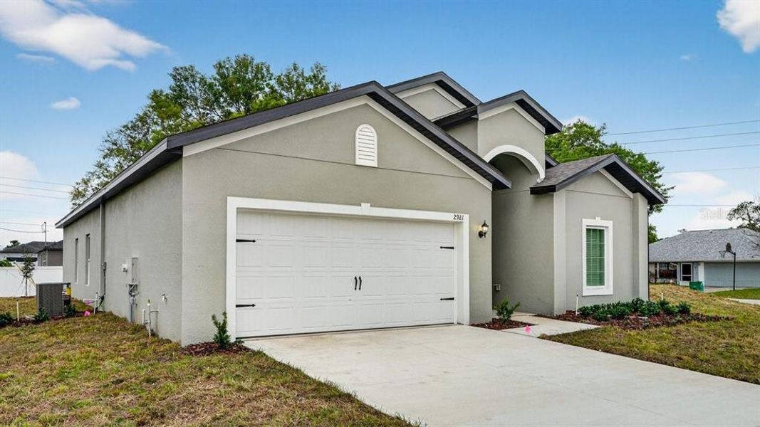 Front exterior of a new home in , Deltona, FL, highlighting curb appeal (Image 21). Front exterior of a new home in , Deltona, FL, highlighting curb appeal (Image 21).