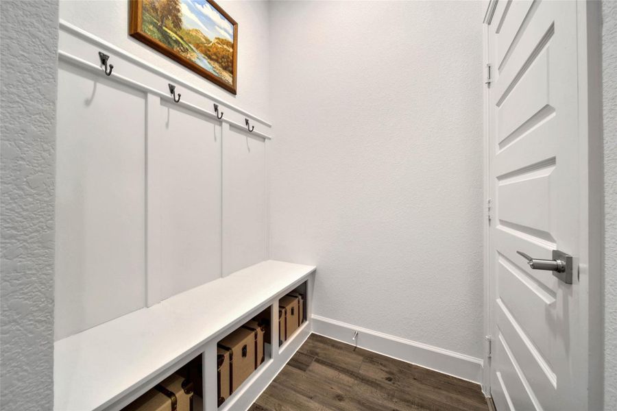 Convenient drop zone just inside the garage entry features a bench, cubbies & hooks—perfect for keeping everyday essentials organized and out of sight.