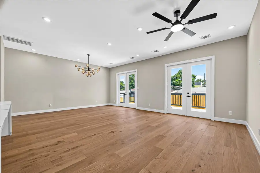 Spacious family room featuring double French doors that provide direct access to the backyard. Spacious family room featuring double French doors that provide direct access to the backyard.