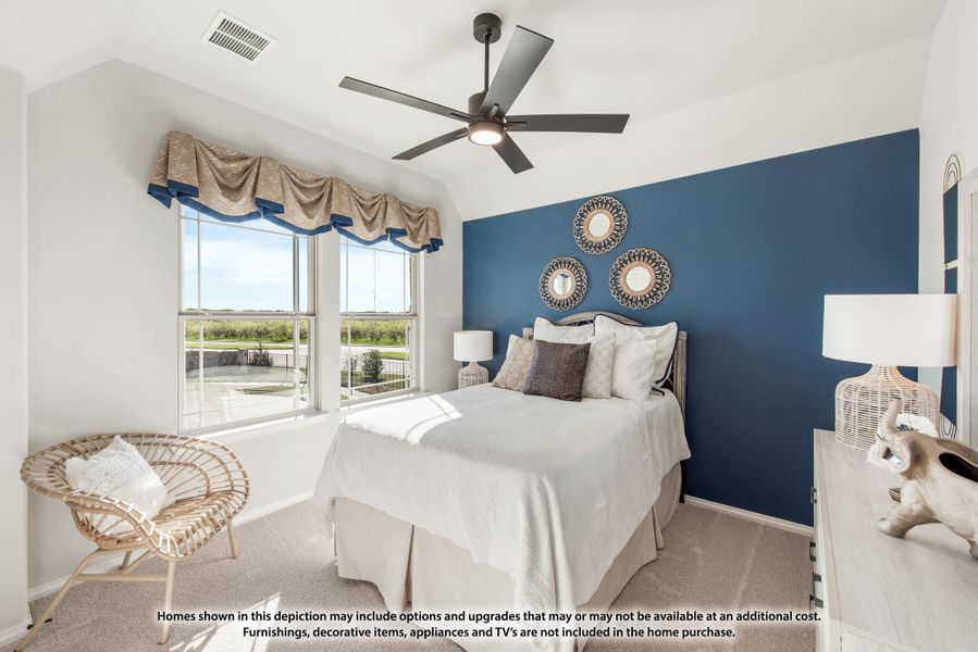 Bedroom with blue accent wall, ceiling fan, vaulted ceiling, and large windows with garden views