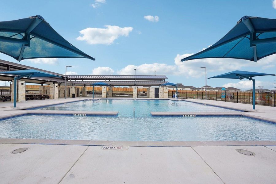 A refreshing community pool with covered seating areas offers a perfect escape on sunny days. A refreshing community pool with covered seating areas offers a perfect escape on sunny days.
