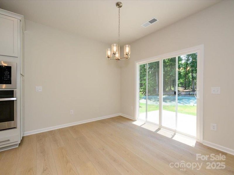 Connected dining space with views to outdoor living. Connected dining space with views to outdoor living.