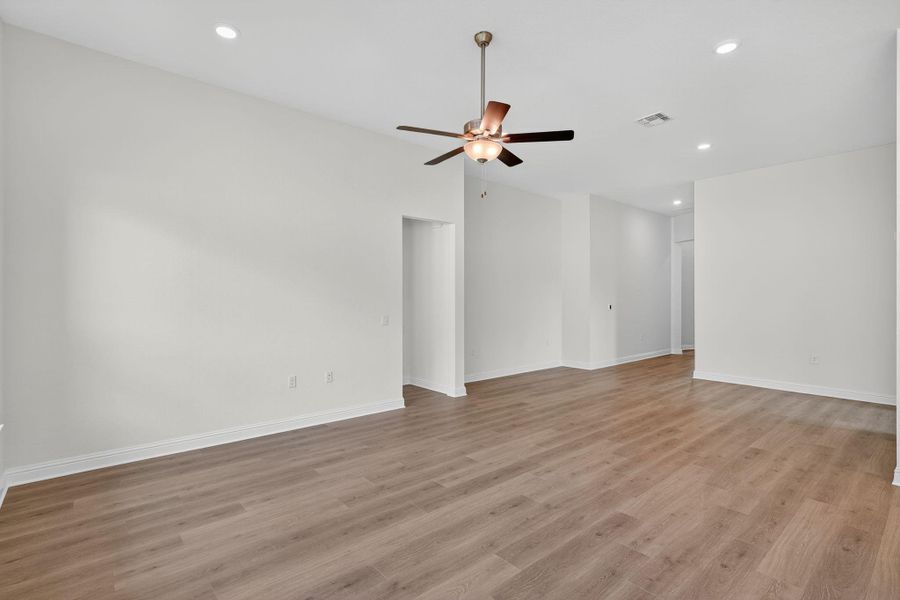 Empty room featuring recessed lighting, light wood finished floors, and a ceiling fan Empty room featuring recessed lighting, light wood finished floors, and a ceiling fan