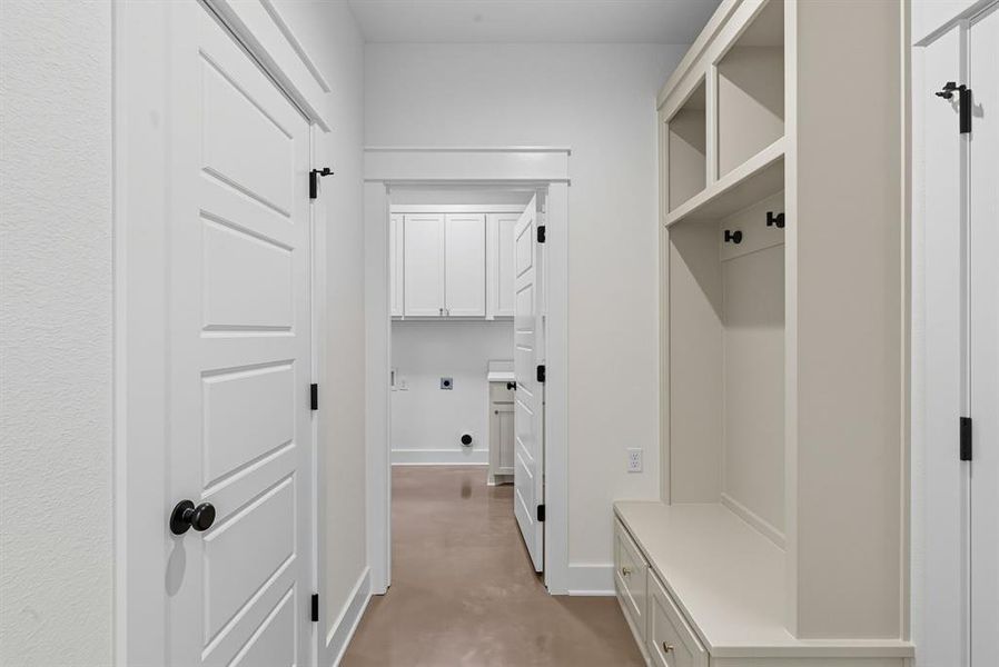 Mudroom featuring finished concrete floors and baseboards