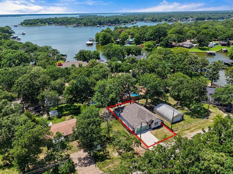 Aerial view of property and surrounding area with property parcel outlined and a large body of water Aerial view of property and surrounding area with property parcel outlined and a large body of water