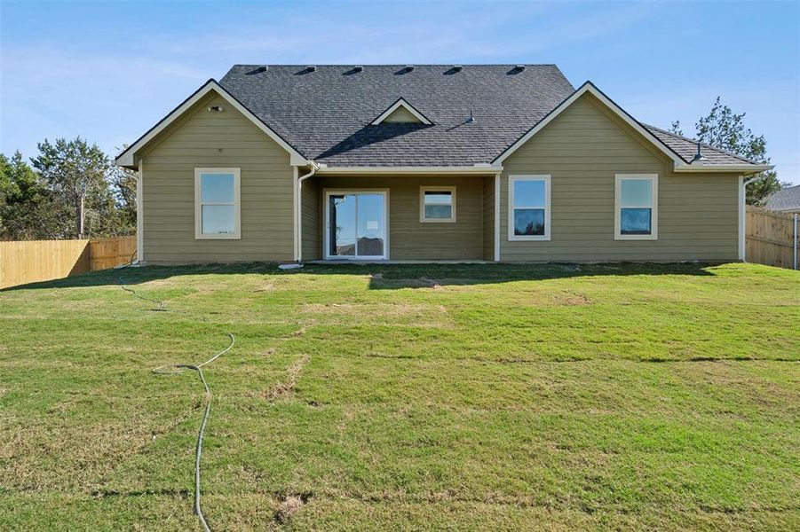 Back of house featuring a lawn