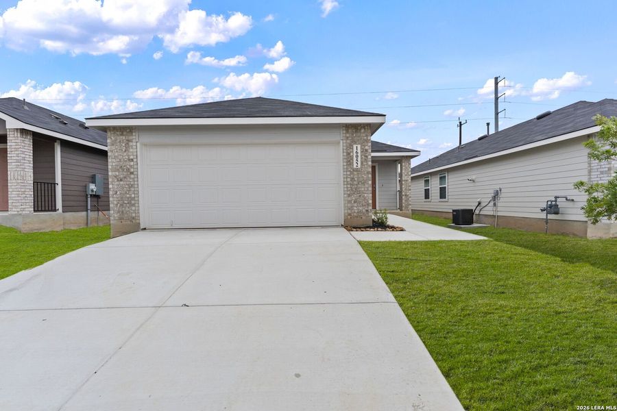 Front exterior of a new home in Hickory Ridge, Elmendorf, TX, highlighting curb appeal (Image 1). Front exterior of a new home in Hickory Ridge, Elmendorf, TX, highlighting curb appeal (Image 1).
