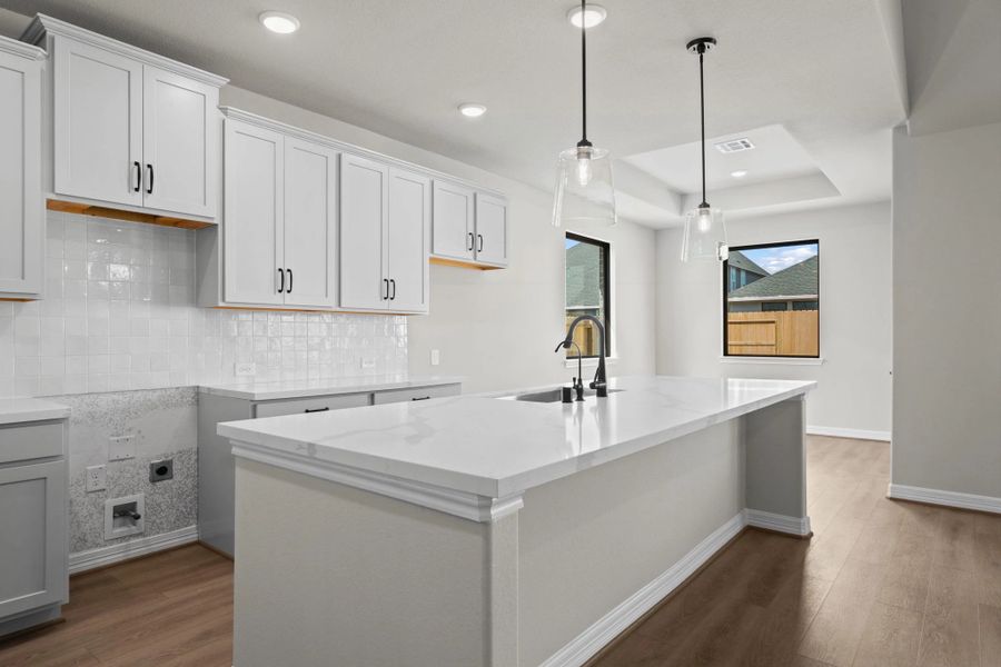 Kitchen and dining area. Note: Sample product photo. Actual exterior and interior selections may vary by homesite. Photo may be virtually staged